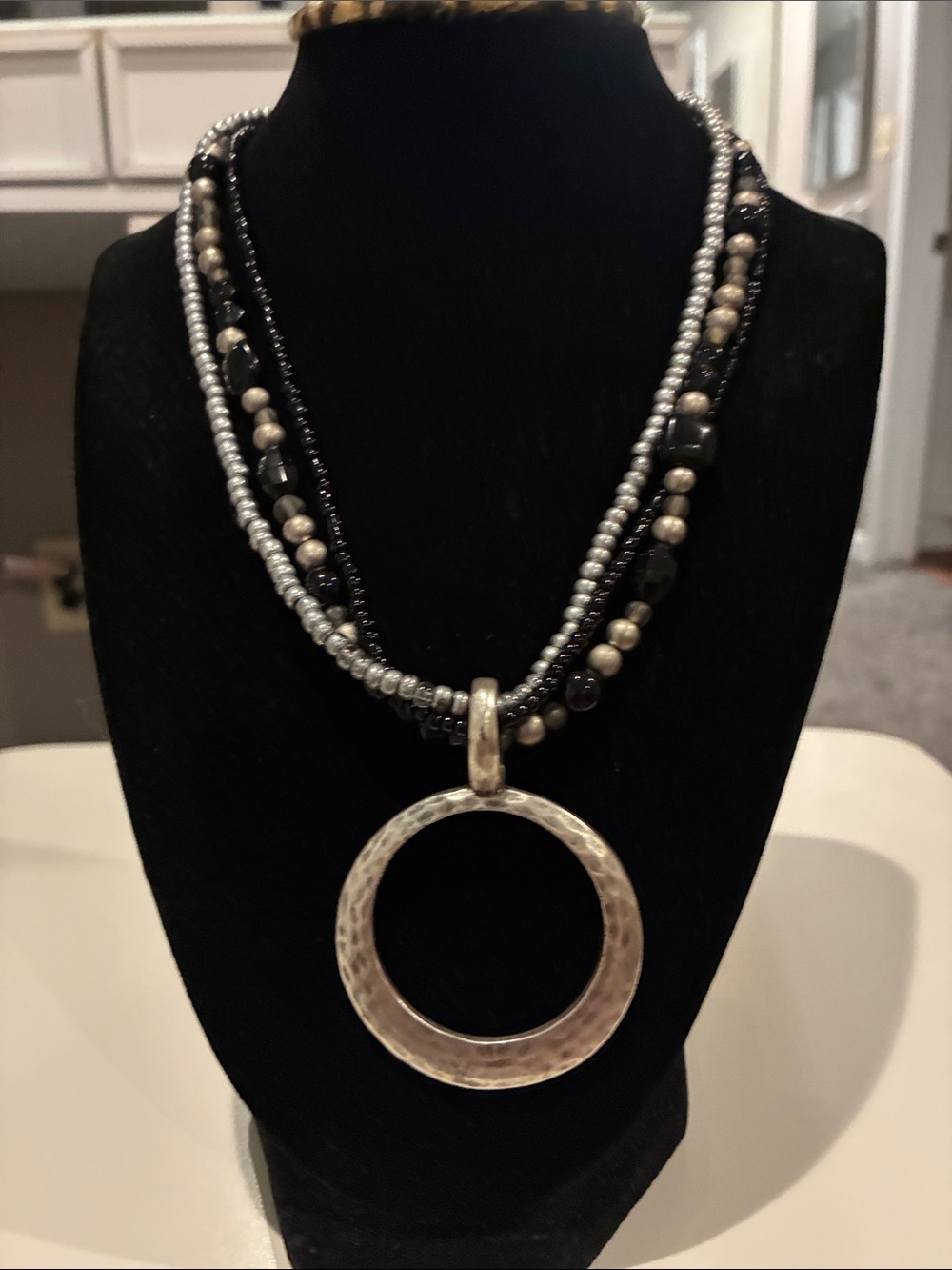 Multi-Strand Black and Silver Beaded Necklace with Hammered Circle Pendant